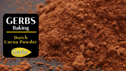 Heap of Gerbs dutch cocoa powder on black background. Close-up.