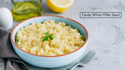 Bowl of freshly made Millet Seed with fork and butter.