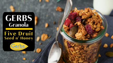 Gerbs super fruit n' Honey granola in a glass jar bowl and spoon.
