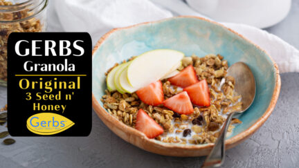 Bowl of Gerbs original seed n honey granola with fresh strawberries and apple slices.