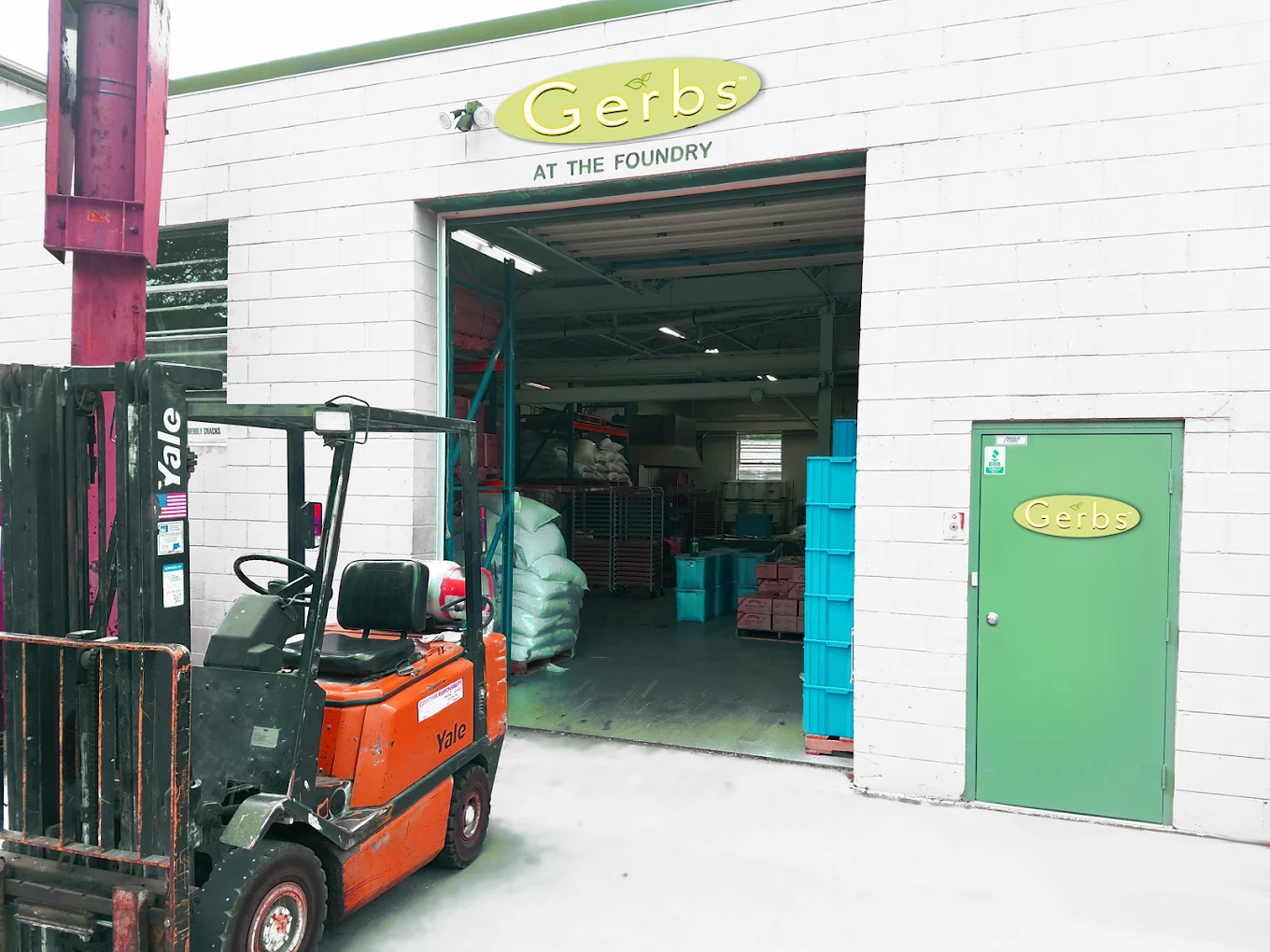 The Gerbs At The Foundry production facility exterior in Johnston, Rhode Island, with a forklift at the loading bay