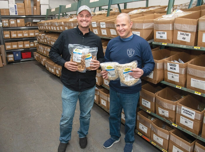 Sennen and Galen Conte, founders of Gerbs, holding Gerbs product bags in the Johnston, Rhode Island production warehouse